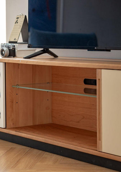 Wooden TV stand with a glass shelf and electronic devices on top.