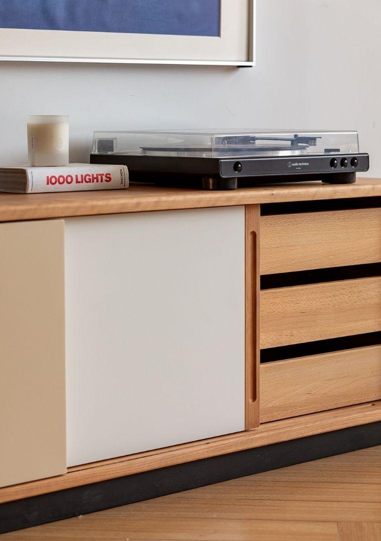 Wooden cabinet with a record player on top, featuring a book titled &