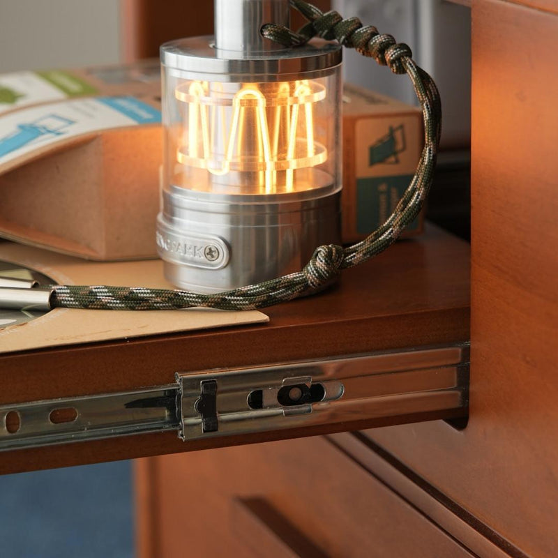 Small lamp with a braided cord on a wooden surface